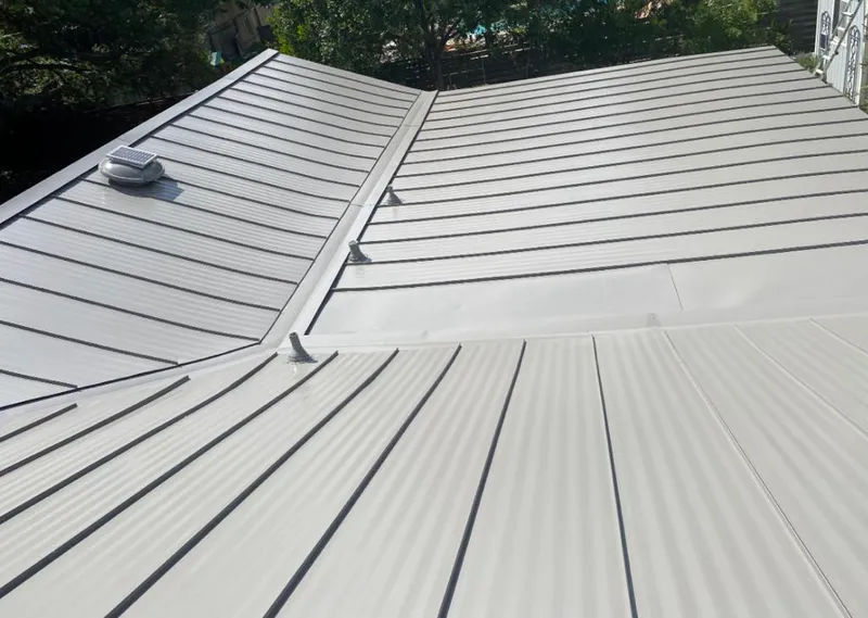 Solar attic fan installed on a metal roof for Roof Ventilation in Cumming